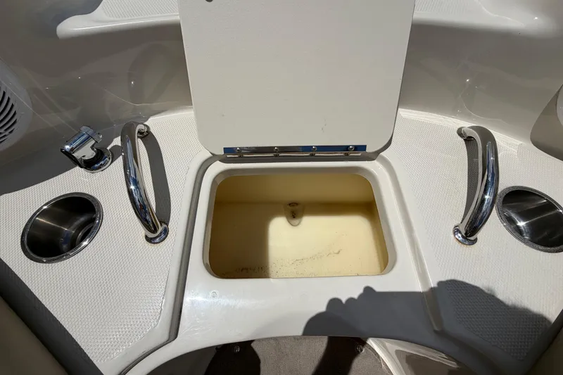 Slide: The Image of Open storage compartment on a 2004 Sea Ray 240 Sundeck boat deck. - 26