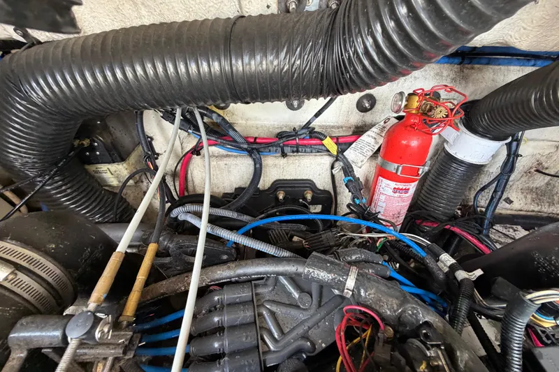 Slide: The Image of Engine compartment of a 2004 Sea Ray 240 Sundeck with visible wiring and fire extinguisher. - 33