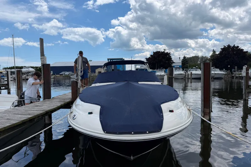 Slide: The Image of 2004 Sea Ray 240 Sundeck docked at marina under cloudy sky. - 36