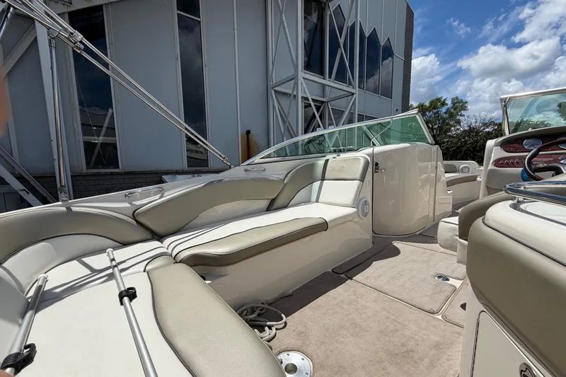 Slide: The Image of 2004 Sea Ray 240 Sundeck boat interior with beige seating and modern design. - 9