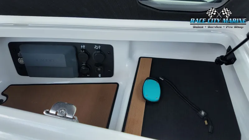 Slide: The Image of The image shows part of the interior of a 2022 Nautique G25 boat with electronic connections. - 25