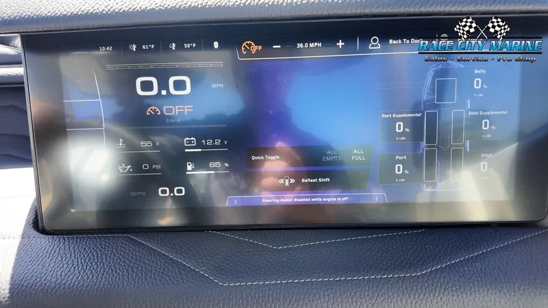 Slide: The Image of The image shows the digital dashboard of a 2022 Nautique G25 with various displays and controls. - 38