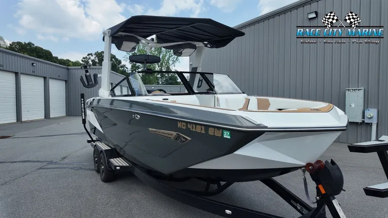 Slide: The Image of A 2022 Nautique G25 boat on a trailer in a warehouse area. - 5