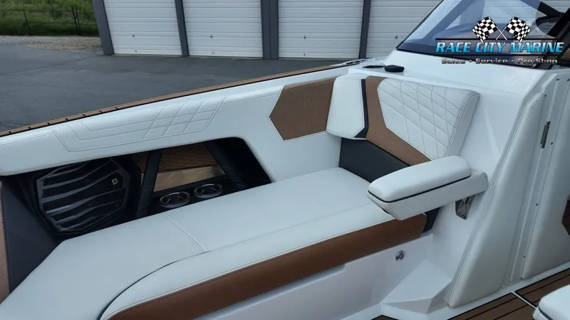 Slide: The Image of The image shows the interior of a 2022 Nautique G25 with white and brown upholstery. - 15