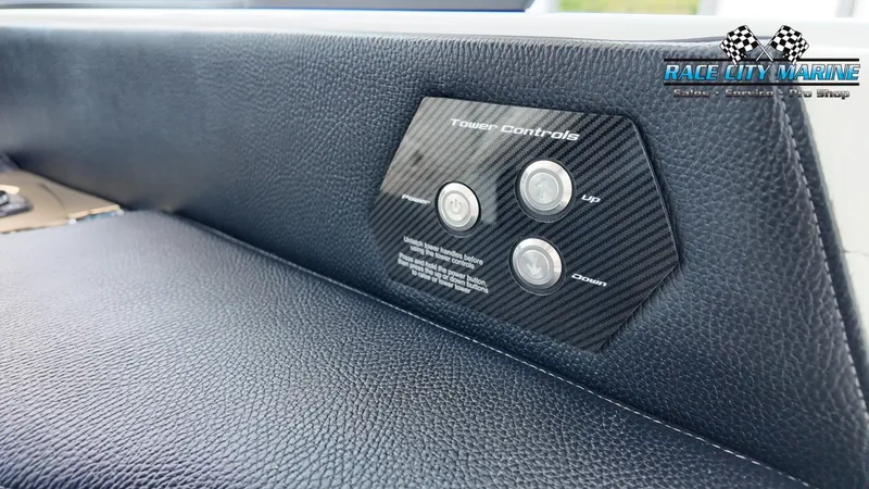 Slide: The Image of Close-up of the tower controls inside a 2022 Nautique G25. - 49