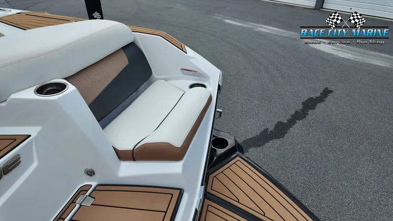 Slide: The Image of The image shows the stern of a 2022 Nautique G25 boat with sleek seating and teak accents. - 13