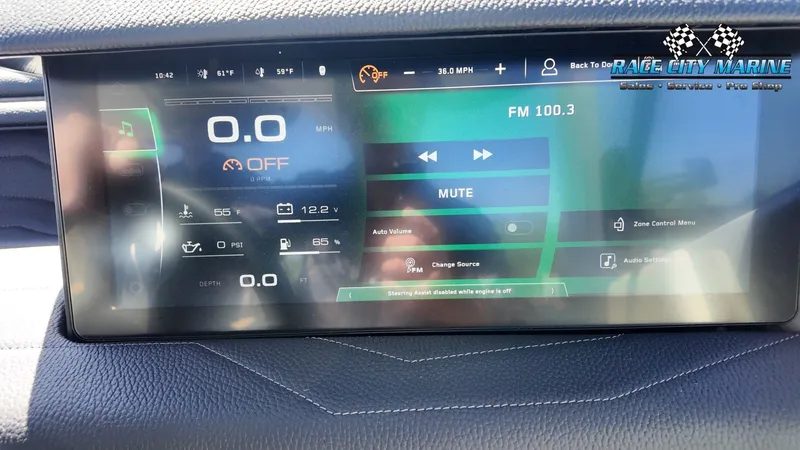 Slide: The Image of The image shows a modern dashboard with a digital display in a Nautique G25 boat. - 34