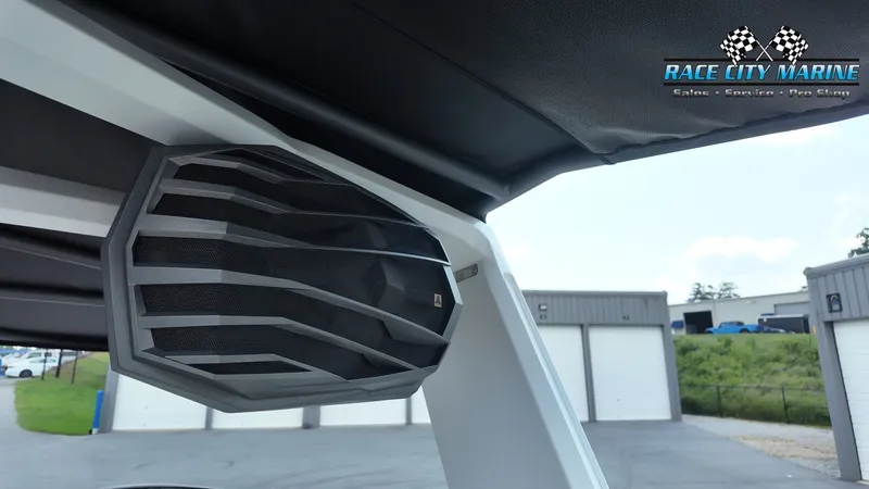 Slide: The Image of A speaker is mounted inside a boat, with a building visible in the background. - 20