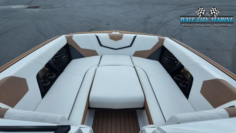 Slide: The Image of The image shows the interior of a 2022 Nautique G25 with luxurious white and brown upholstery. - 42