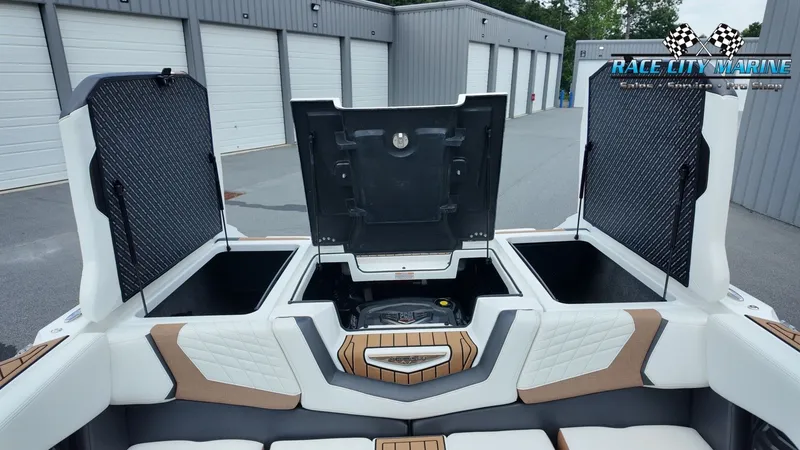 Slide: The Image of The image shows the rear area of a 2022 Nautique G25 with open storage compartments. - 30