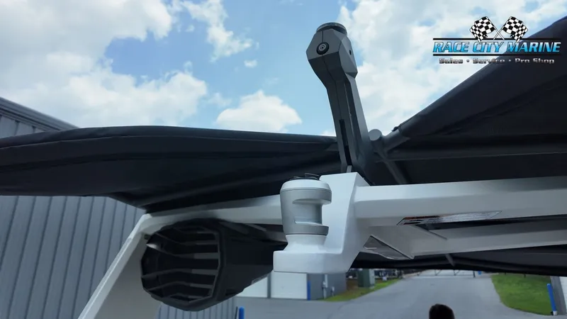 Slide: The Image of A modern boat canopy with speakers and a sturdy frame under a cloudy sky. - 24