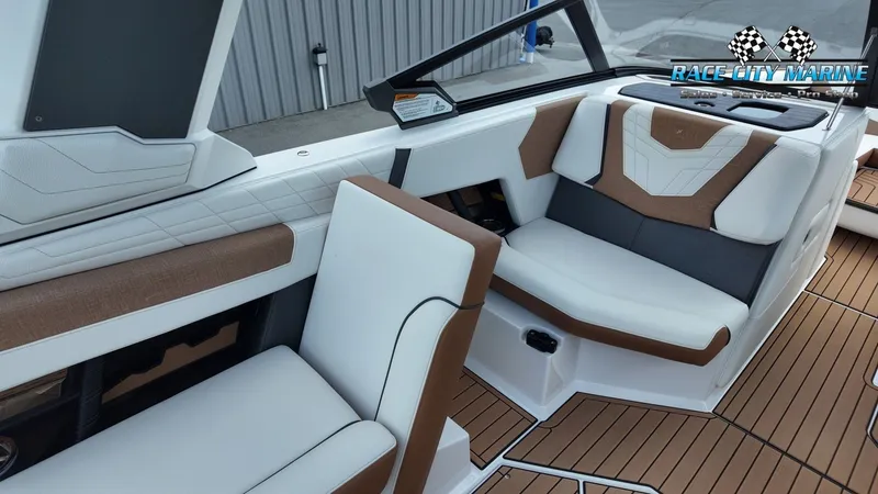 Slide: The Image of The image shows the interior of a 2022 Nautique G25 with sleek white and brown seating. - 46