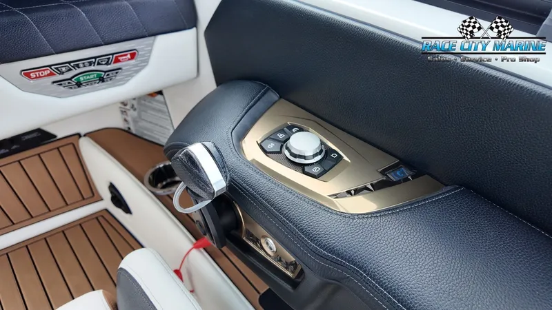 Slide: The Image of Close-up of the control area on a 2022 Nautique G25 boat with modern controls. - 29
