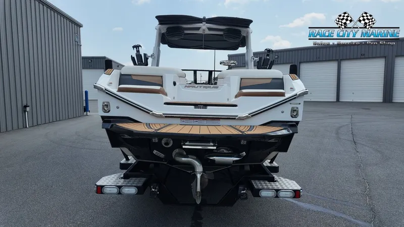 Slide: The Image of The image shows the rear of a 2022 Nautique G25 boat in a warehouse. - 4