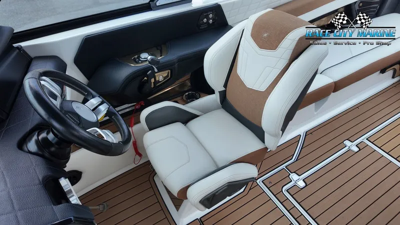 Slide: The Image of The image shows the interior of a 2022 Nautique G25 with luxurious seating and wood flooring. - 16