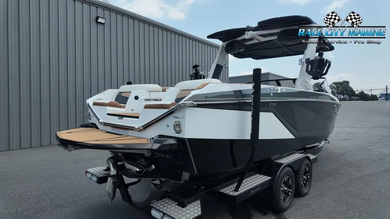 Slide: The Image of 2022 Nautique G25 with sleek design, parked on a trailer in front of a building. - 8