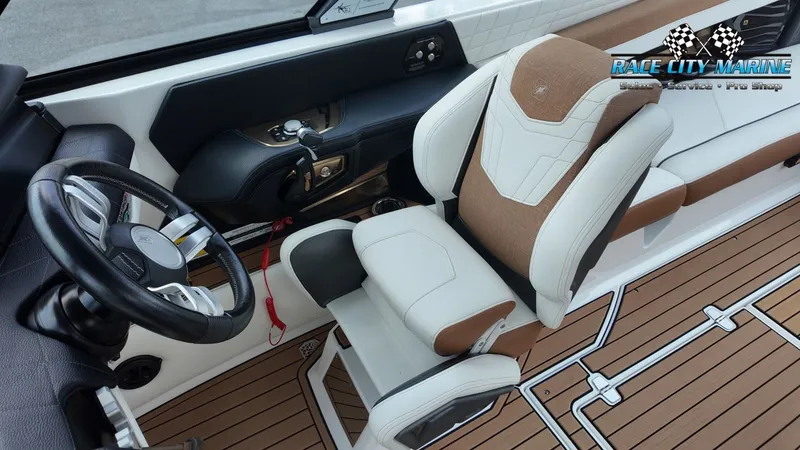 Slide: The Image of The image shows the interior of a 2022 Nautique G25 with a sleek steering wheel and luxurious seat. - 48
