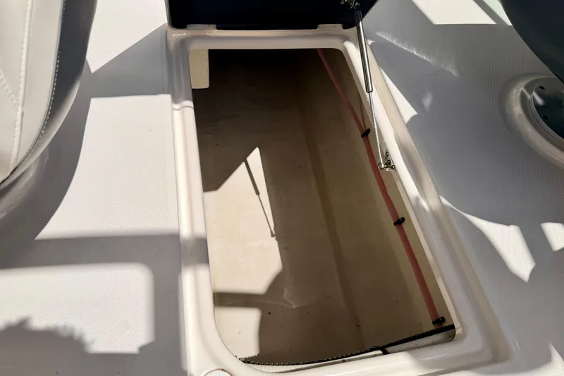 Slide: The Image of Storage compartment on a 2015 Chaparral Sunesta 264 boat, open and empty. - 100