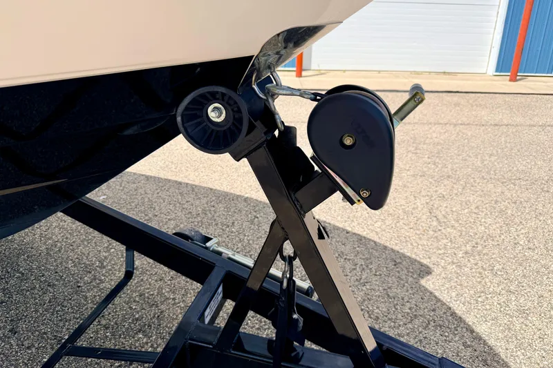 Slide: The Image of 2015 Chaparral Sunesta 264 boat trailer hitch detail in a parking area. - 106