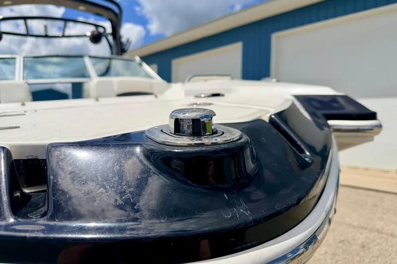 Slide: The Image of 2015 Chaparral Sunesta 264 boat detail with chrome hardware, blue sky background. - 108