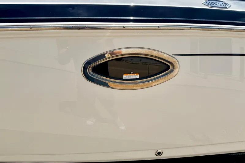 Slide: The Image of 2015 Chaparral Sunesta 264 boat hull with oval window detail. - 112