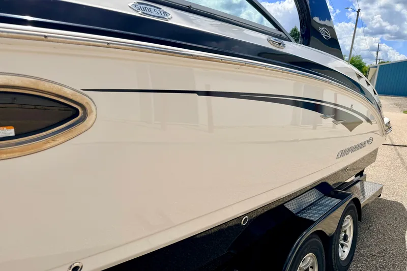 Slide: The Image of 2015 Chaparral Sunesta 264 boat side view with sleek design and trailer. - 113