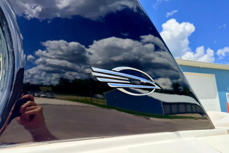 Slide: The Image of 2015 Chaparral Sunesta 264 emblem with sky reflection on glossy surface. - 115