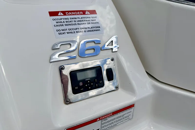 Slide: The Image of 2015 Chaparral Sunesta 264 boat control panel with safety warning labels. - 19