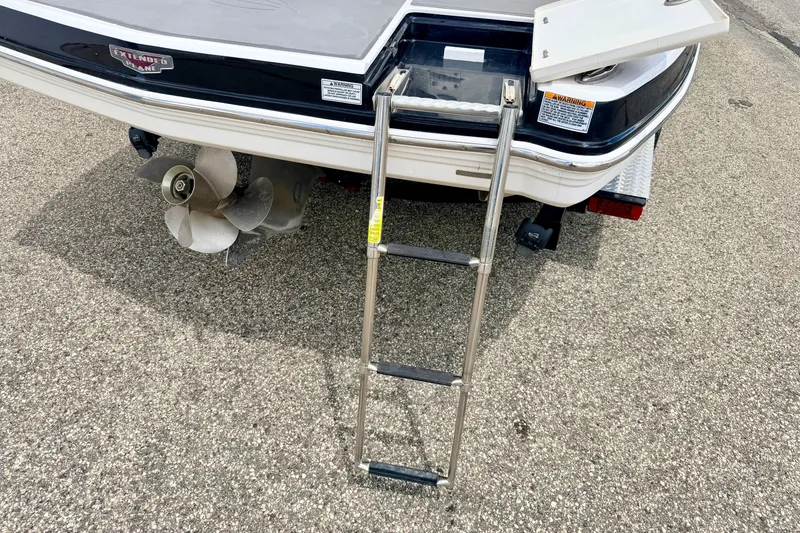 Slide: The Image of 2015 Chaparral Sunesta 264 boat stern with ladder and propeller on pavement. - 22