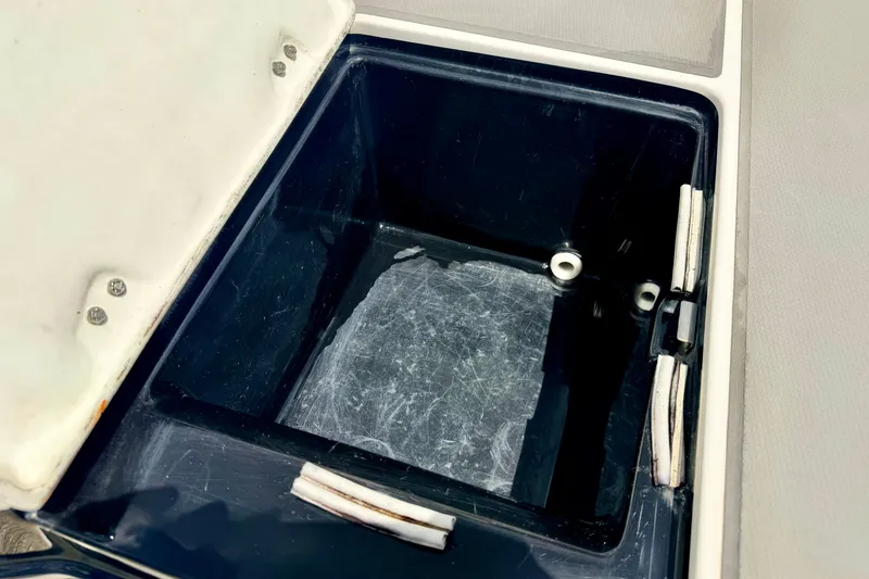 Slide: The Image of Open storage compartment on a 2015 Chaparral Sunesta 264 boat. - 23