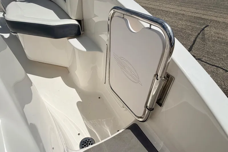 Slide: The Image of 2015 Chaparral Sunesta 264 boat interior with seating and stainless steel gate. - 26