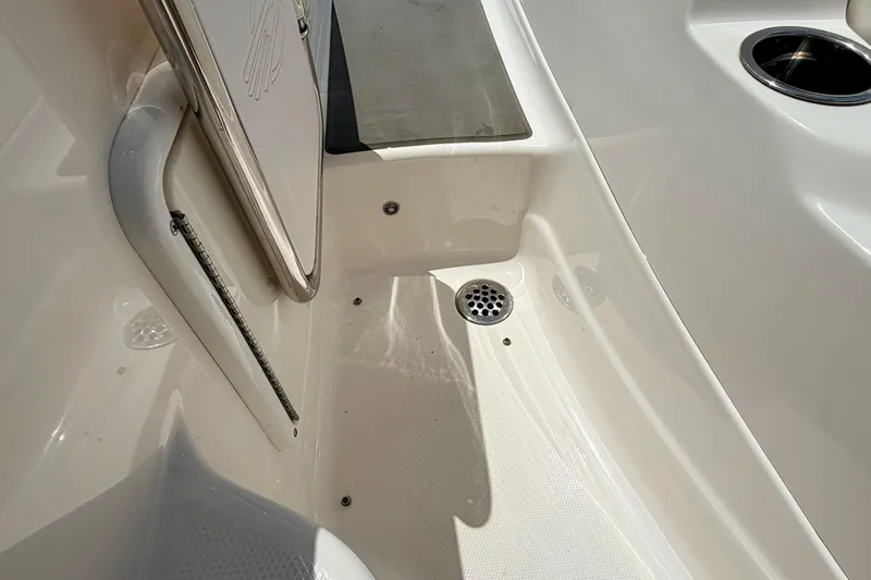 Slide: The Image of 2015 Chaparral Sunesta 264 boat interior with drain and cup holder. - 29