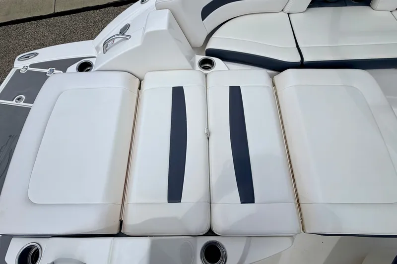 Slide: The Image of 2015 Chaparral Sunesta 264 boat seating area with white and navy upholstery. - 30