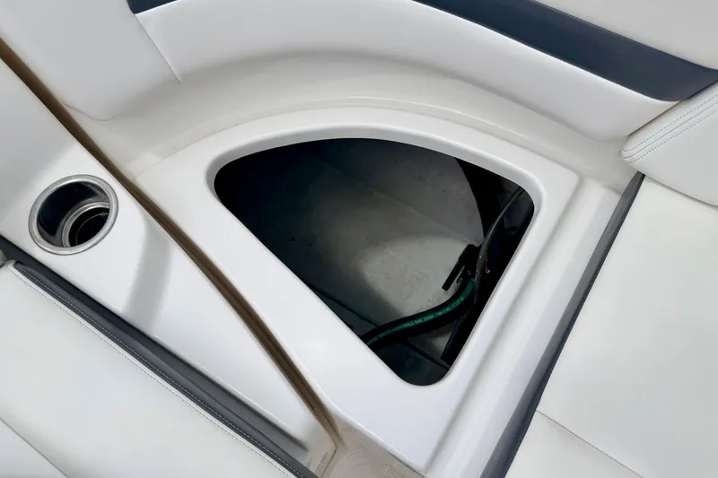 Slide: The Image of Storage compartment in 2015 Chaparral Sunesta 264 boat, featuring sleek white interior design. - 32