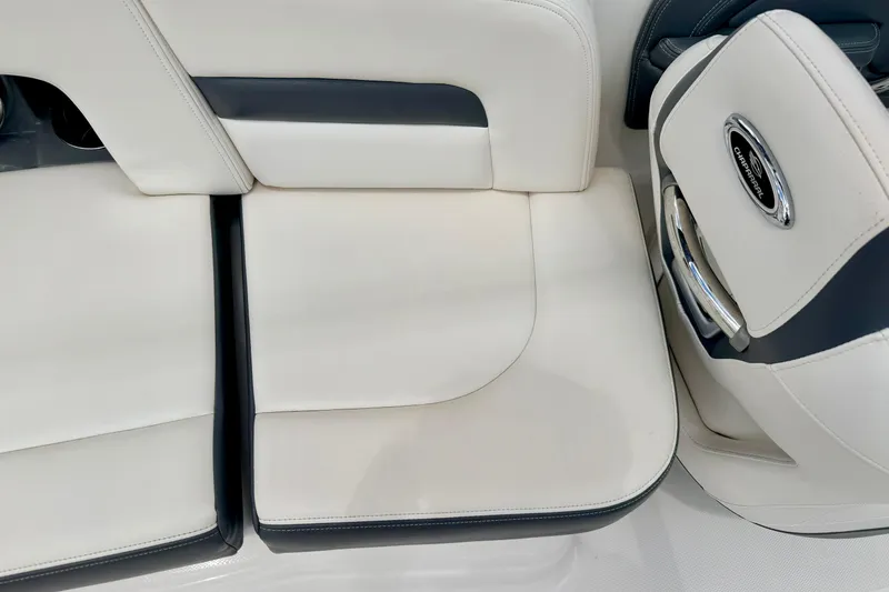 Slide: The Image of 2015 Chaparral Sunesta 264 boat interior seating, featuring white and black upholstery. - 36