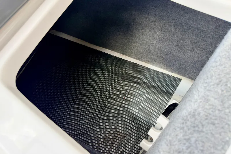 Slide: The Image of Storage compartment in 2015 Chaparral Sunesta 264 boat, featuring carpeted interior. - 37
