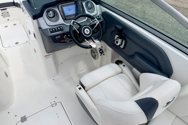 Slide: The Image of 2015 Chaparral Sunesta 264 boat interior with steering wheel and dashboard controls. - 41