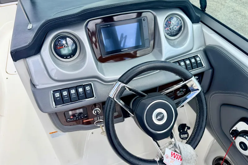 Slide: The Image of Dashboard of 2015 Chaparral Sunesta 264 boat with steering wheel and controls. - 42