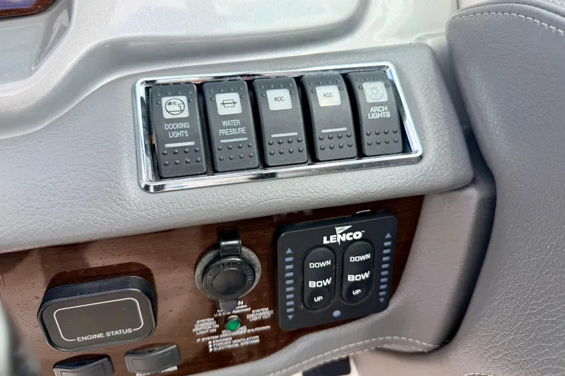 Slide: The Image of Control panel of a 2015 Chaparral Sunesta 264 boat with switches and Lenco controls. - 47