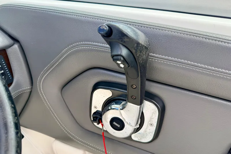 Slide: The Image of 2015 Chaparral Sunesta 264 throttle control lever on gray interior panel. - 48