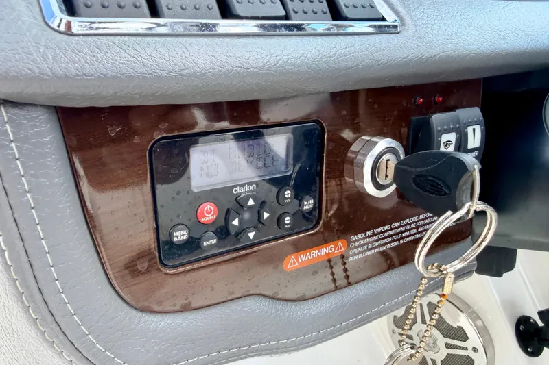 Slide: The Image of Control panel of a 2015 Chaparral Sunesta 264 boat with ignition and stereo system. - 49
