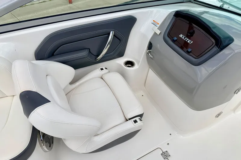 Slide: The Image of 2015 Chaparral Sunesta 264 boat interior with white seating and sleek dashboard design. - 52