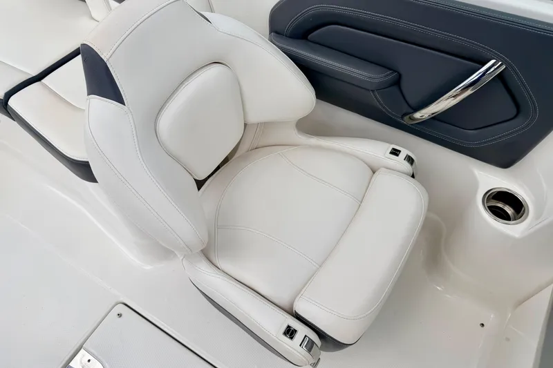 Slide: The Image of 2015 Chaparral Sunesta 264 boat seat, featuring white upholstery and sleek design. - 53