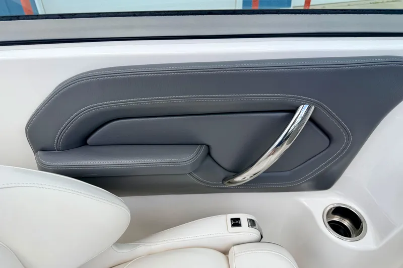 Slide: The Image of 2015 Chaparral Sunesta 264 interior detail with sleek gray panel and chrome handle. - 60