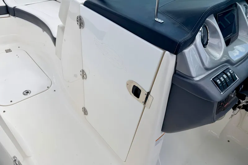 Slide: The Image of 2015 Chaparral Sunesta 264 boat interior, featuring helm controls and seating area. - 61