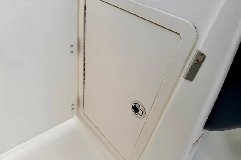 Slide: The Image of 2015 Chaparral Sunesta 264 storage compartment with secure latch and sleek design. - 63