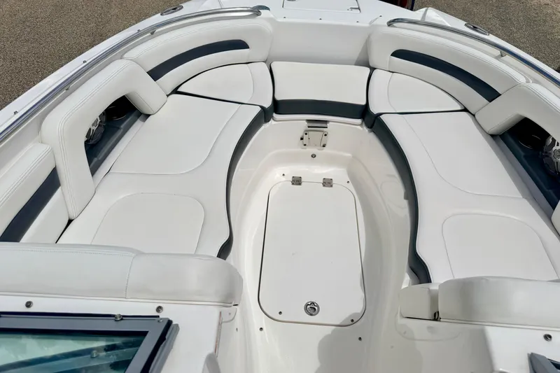 Slide: The Image of 2015 Chaparral Sunesta 264 boat interior with white cushioned seating. - 67