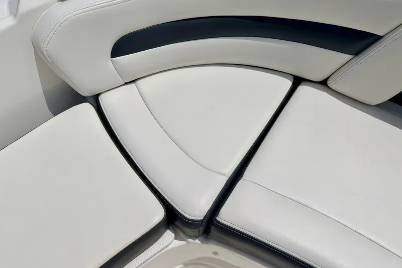 Slide: The Image of 2015 Chaparral Sunesta 264 boat seating with white and black upholstery. - 75