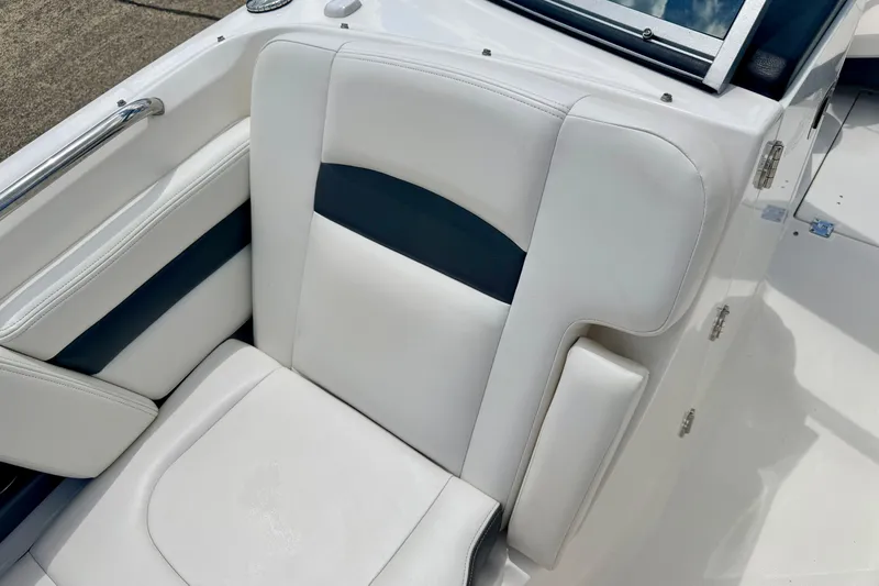 Slide: The Image of 2015 Chaparral Sunesta 264 boat seat with white and navy upholstery. - 78