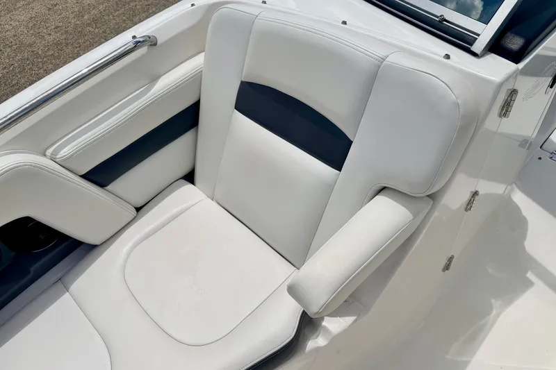 Slide: The Image of 2015 Chaparral Sunesta 264 boat seat with white and navy upholstery. - 79